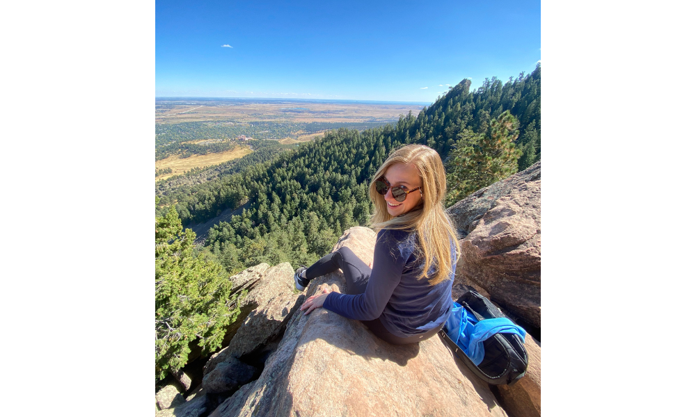 Eirini Boutiou sitting on a mountain in Colorado.