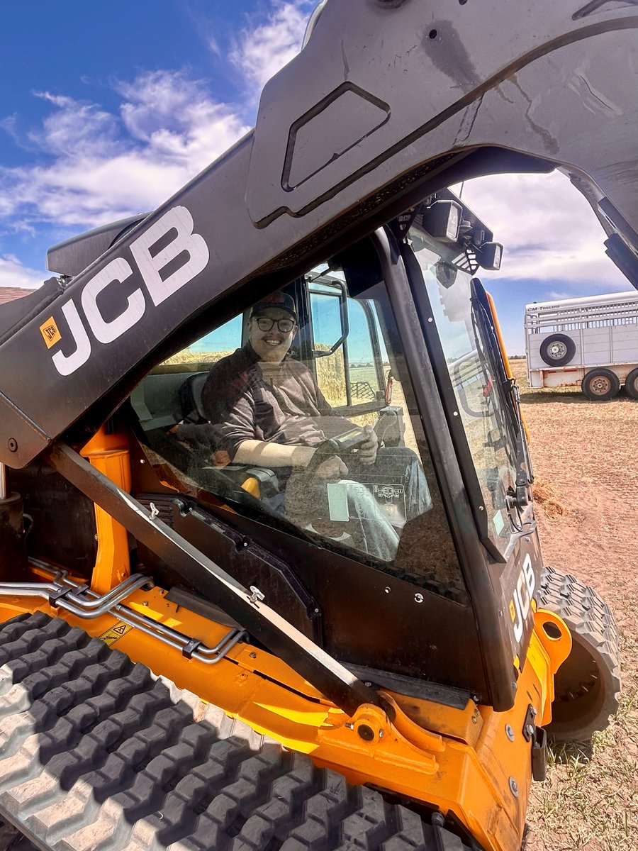 Garrett operates machinery on the ranch, a big smile on his face.