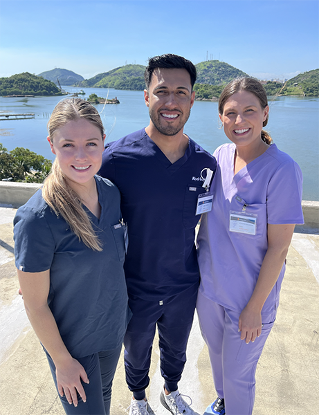 three dental students in scrubs in Brazil