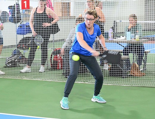 Caro Henauw, grants and contracts manager at the CU Anschutz Health and Wellness Center, plays pickleball at an indoor facility in Westminster.