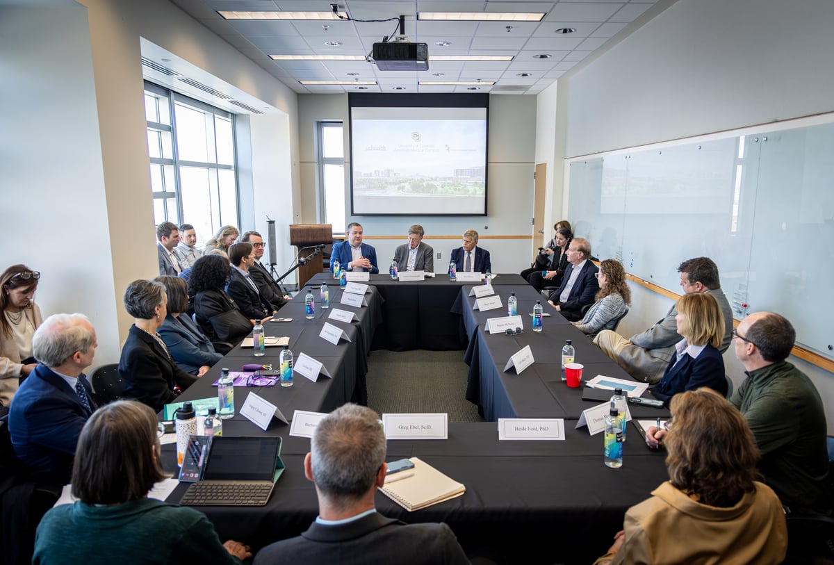 Attendees gathered around a conference table at a recent visit from Sen. Hickenlooper.