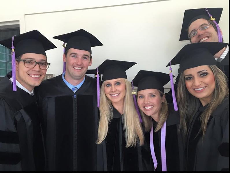 Group of dental graduates in caps and gowns