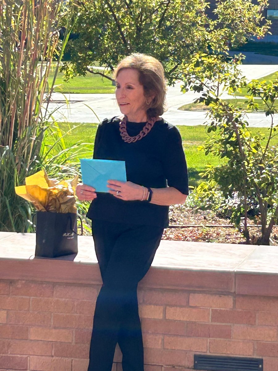 Terri Tilliss with greeting card and gift for her retirement celebration