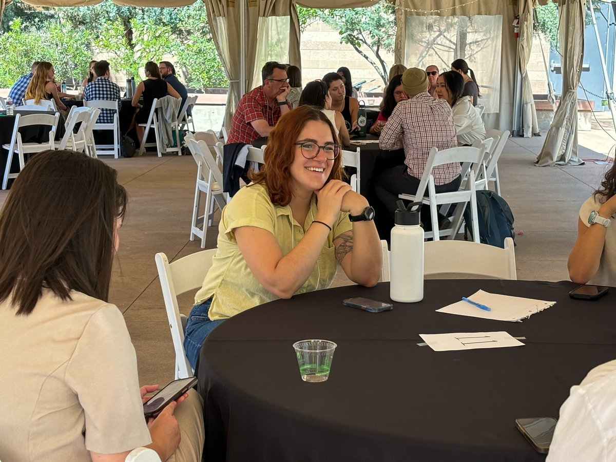 Person smiling at table during the breakout session portion of the retreat