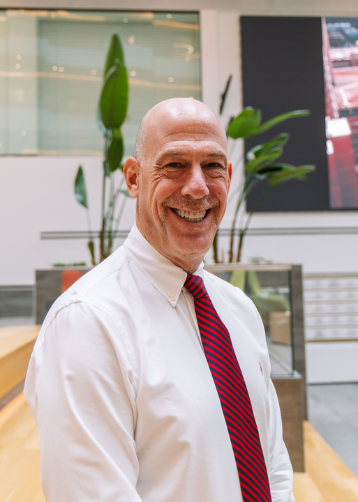 Marc Moss in white shirt and red tie