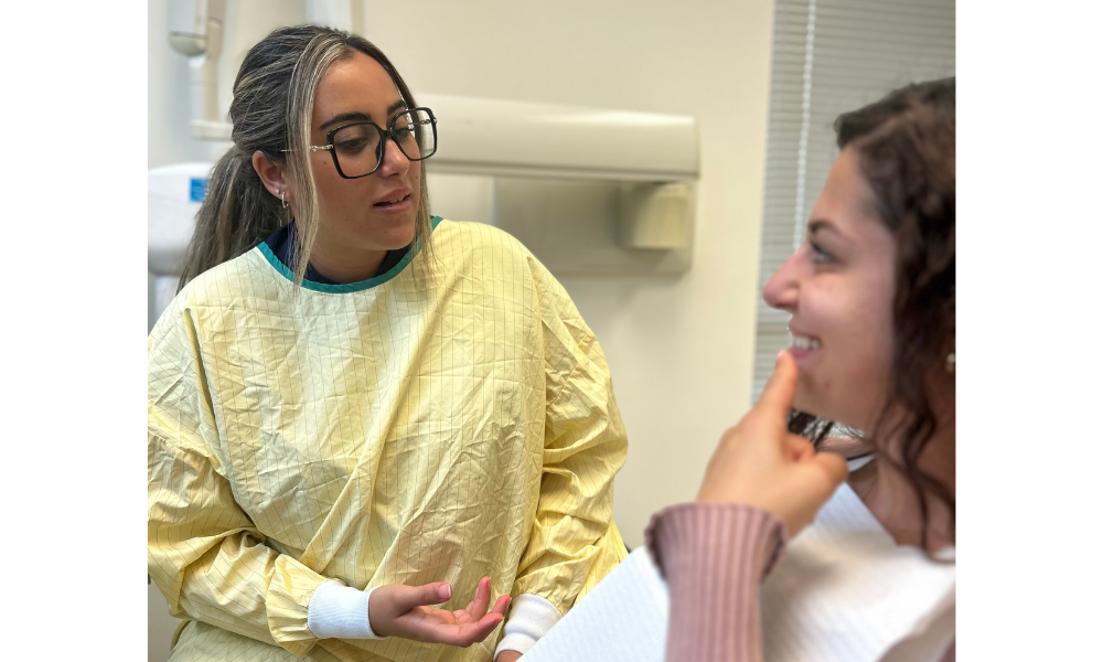 dental student in clinic talking to patient