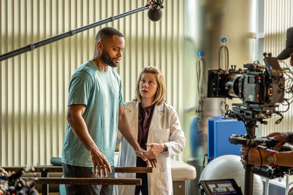 Amanda Piquet helps a patient, while cameras and mics are just in frame during 'Never Dream Alone' filming.