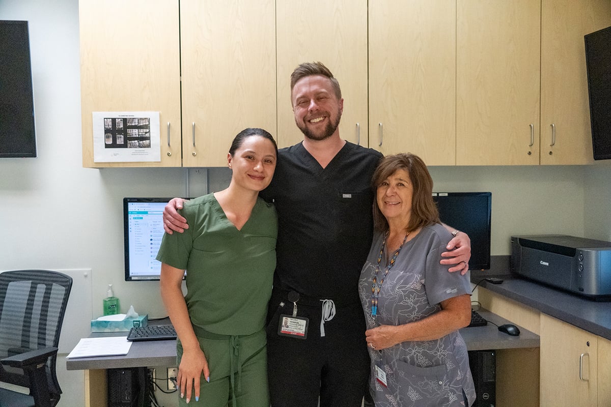 Taylor with two female radiology team members